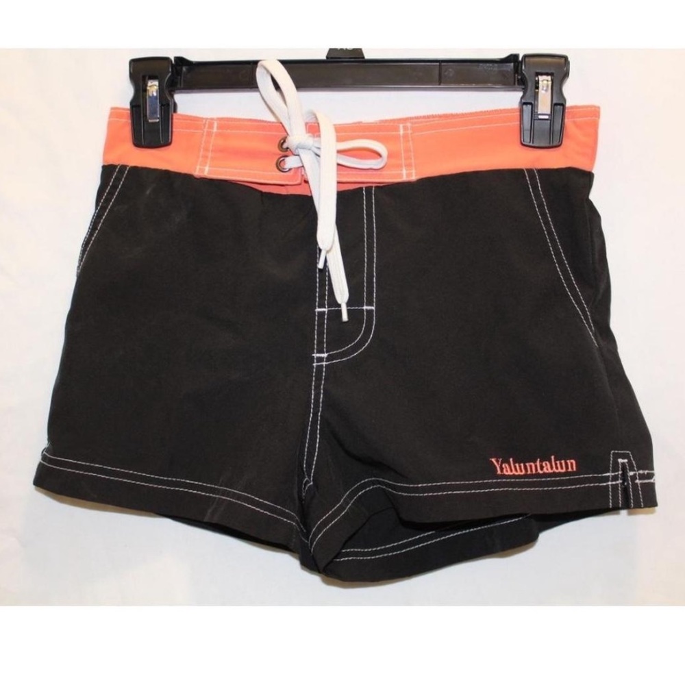 Coral and black board shorts with drawstring.